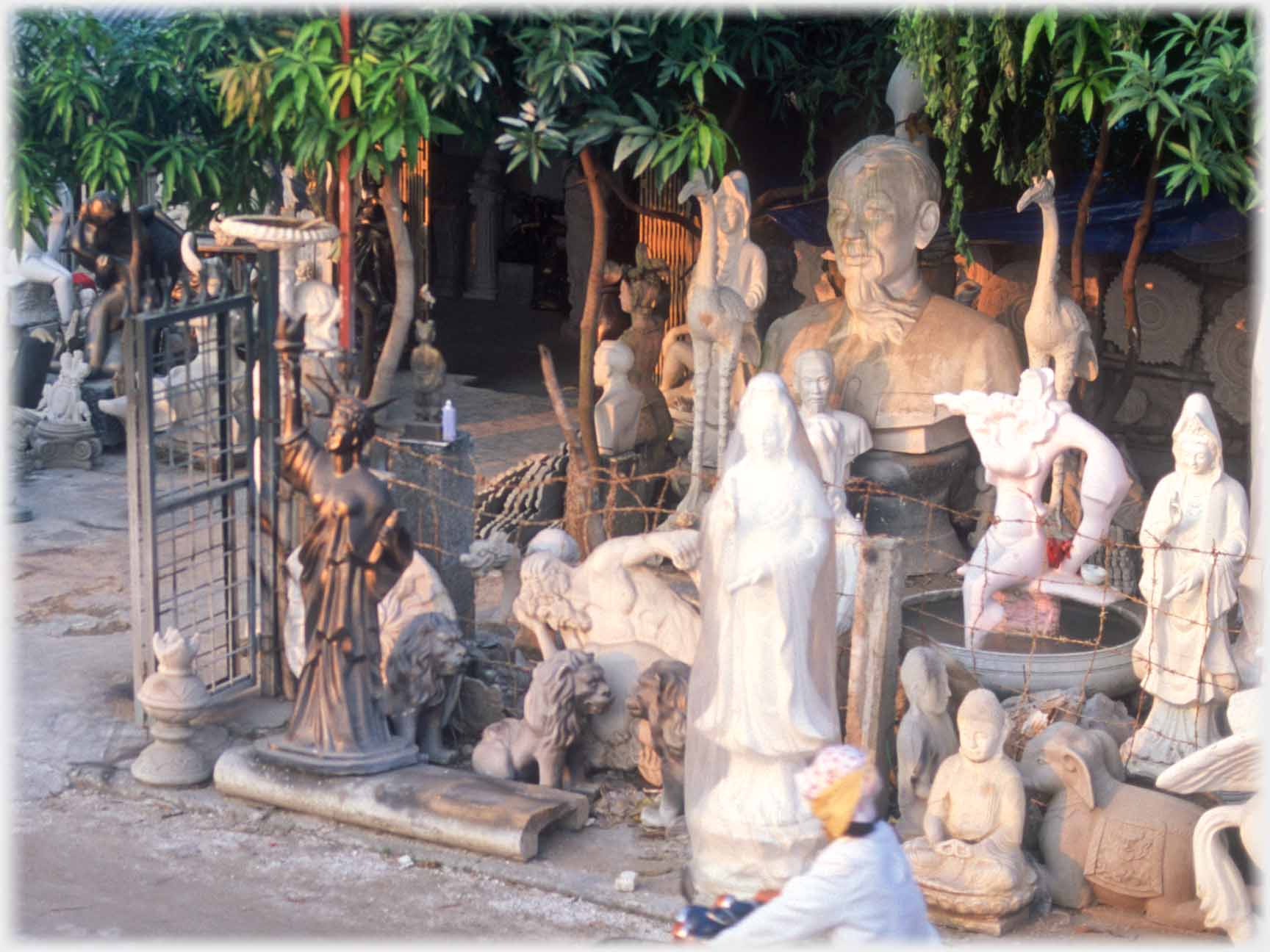 Yard of various statues in various condition dominated by large one of Uncle Ho.