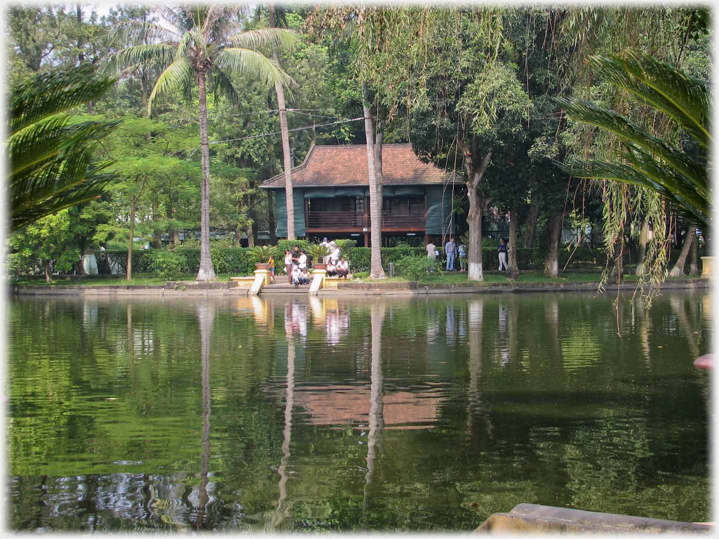 Small stilt house reflected in lake.