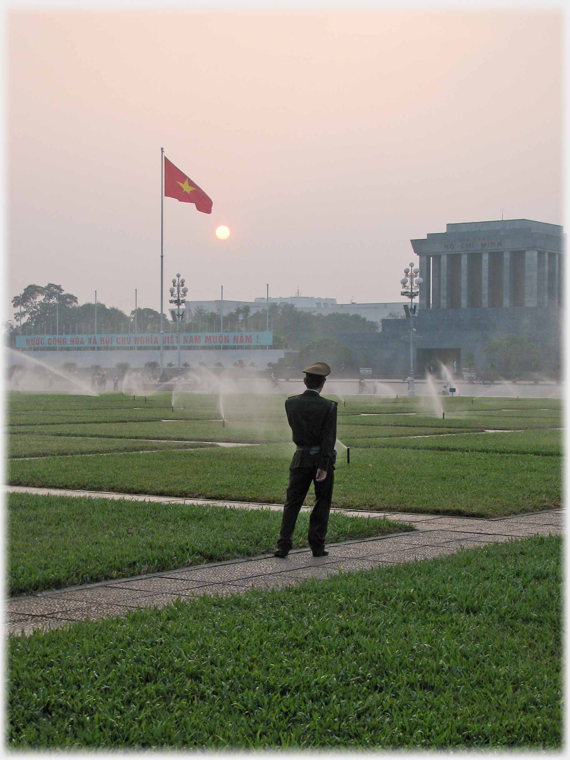 Maulsoleum and sprinklers watched by soldier.