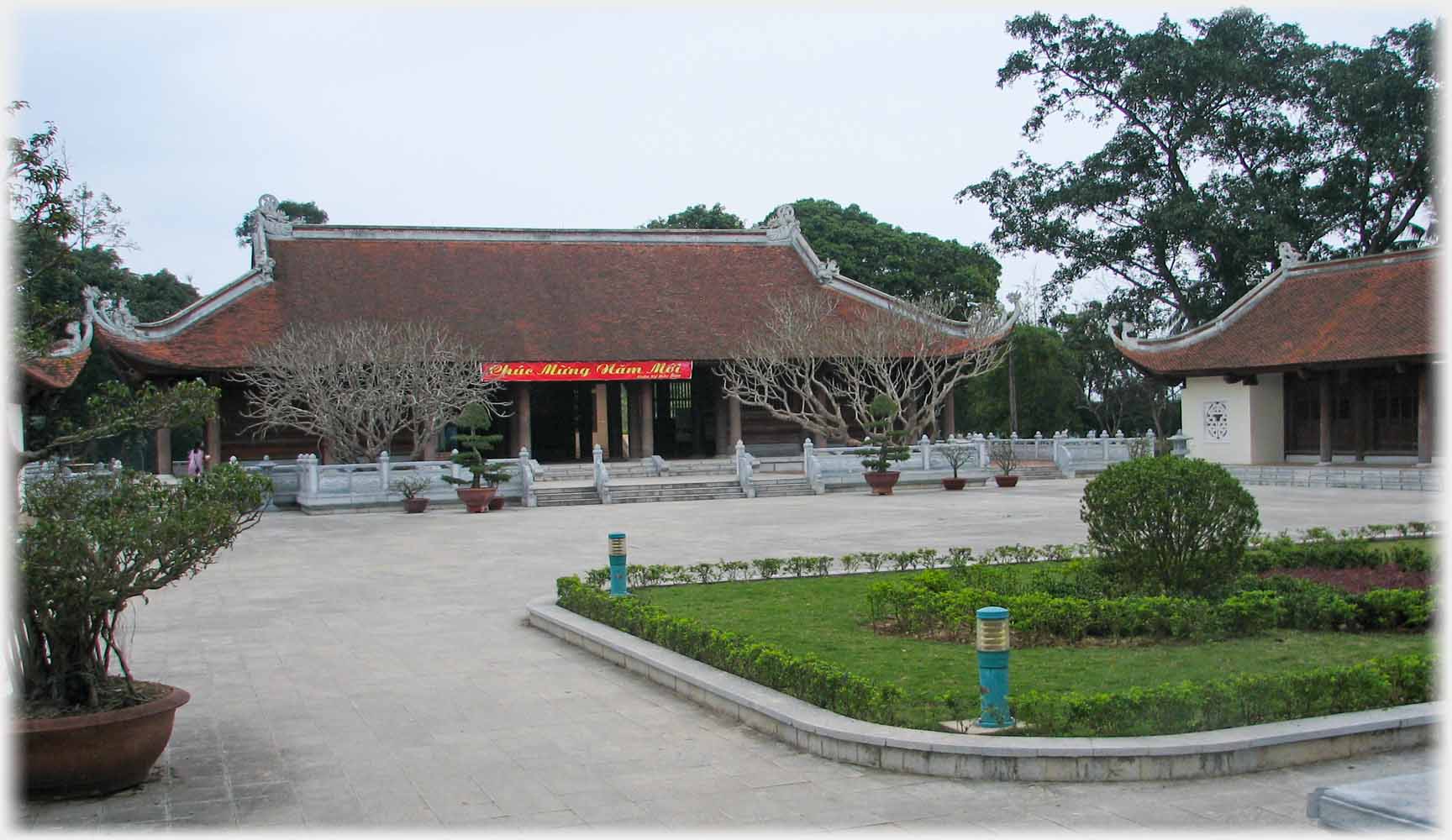 Single story ceremonial buildings on two sides of a square.