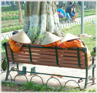 Gardeners sleeping on bench.