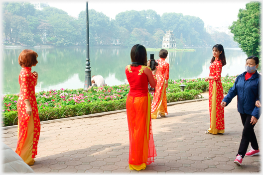 Women in orange Aó Dài 