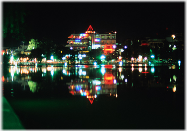 Shark's Jaw building reflected in calm water.