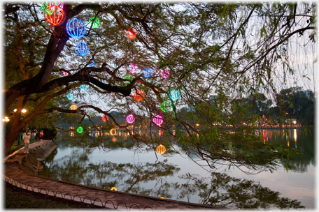 Lanterns in the trees by the lake.