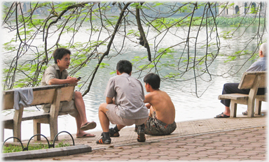 Three men talking by the Lake