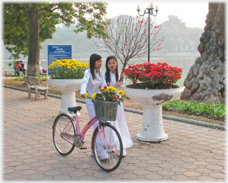 Two women in white Aó Dài