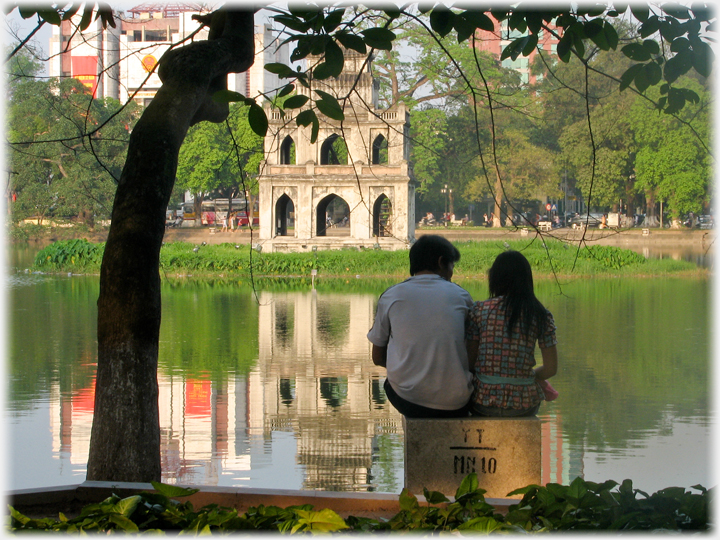 Young couple sitting looking at the monument.