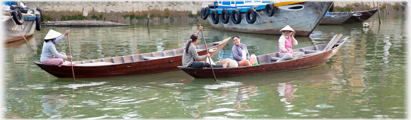 Women in boats conversing.