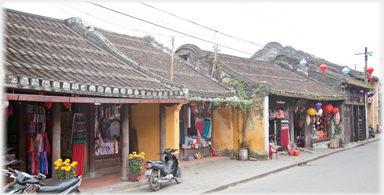 Row of old single story shops.