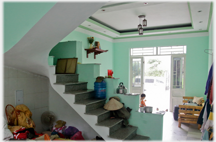 Reception room with staircase and high altar near the main door.