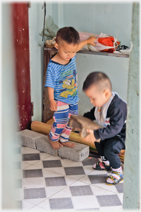 One infant lifting the stool.