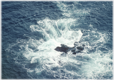 Rocks with the sea swirling around them.