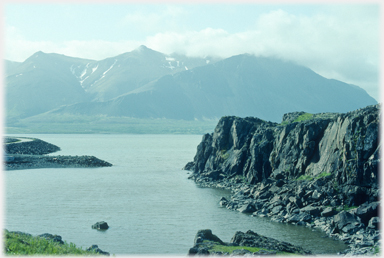 Fjord with rocks and mountains.