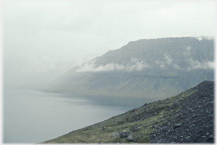 Sea cliffs with cloud traces half way up.