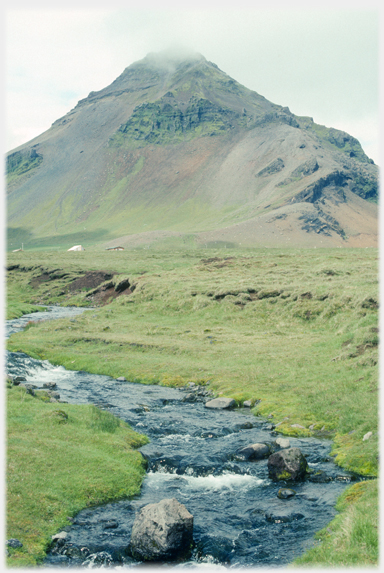 Stream with hill pointed into a cloud.