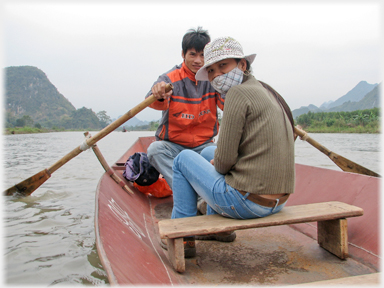 Rowing a metal boat.