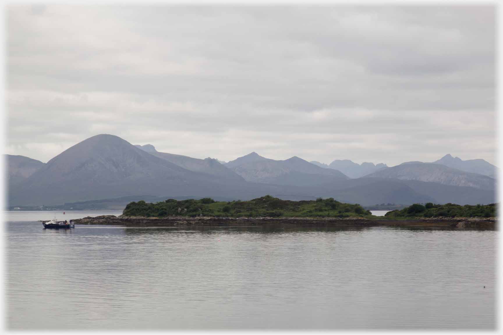 Island, boat, Skye filling the horizon.