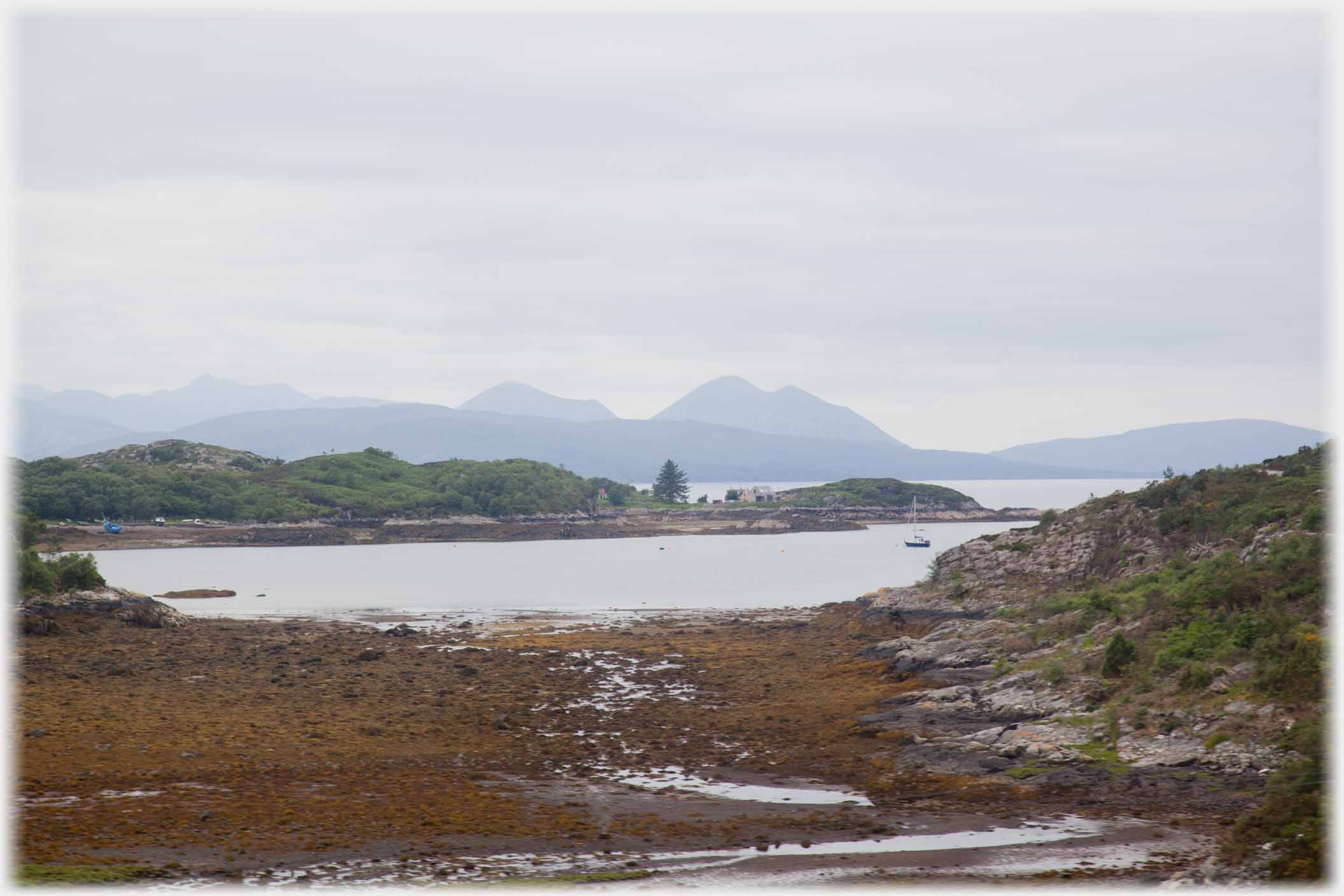 Bay with houses and peaks beyond.