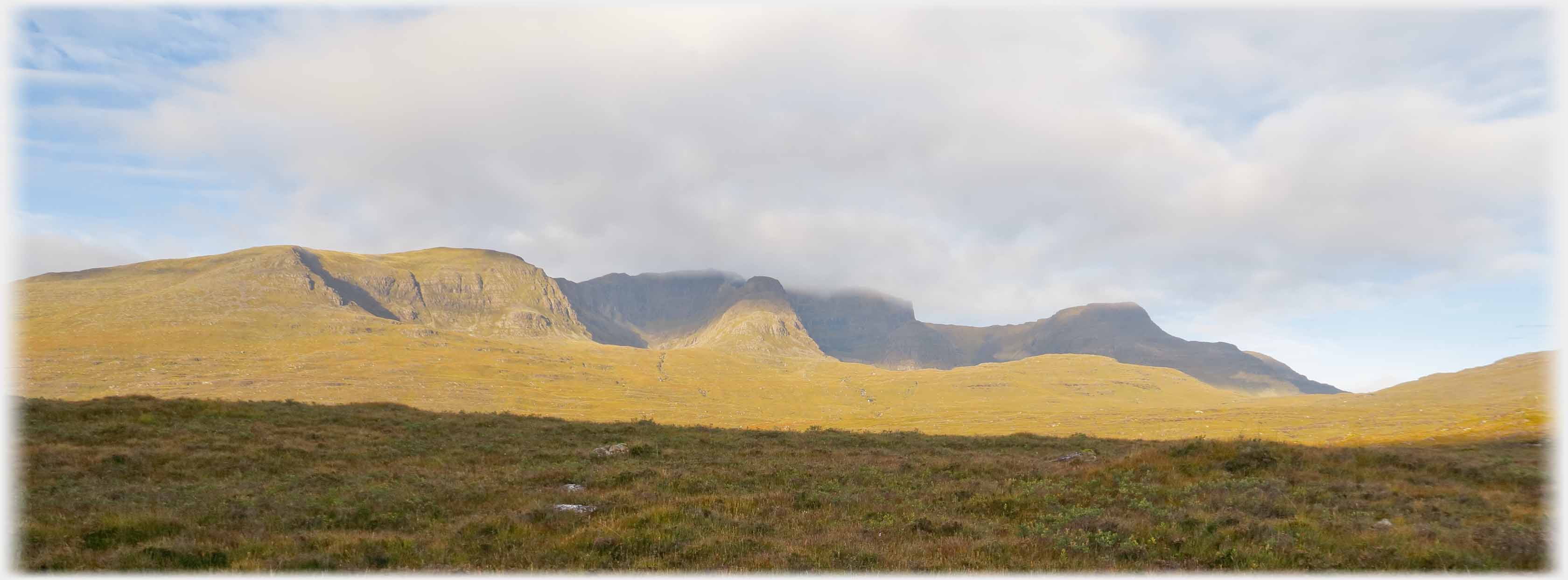 Range of hills forming a extensive barrier.