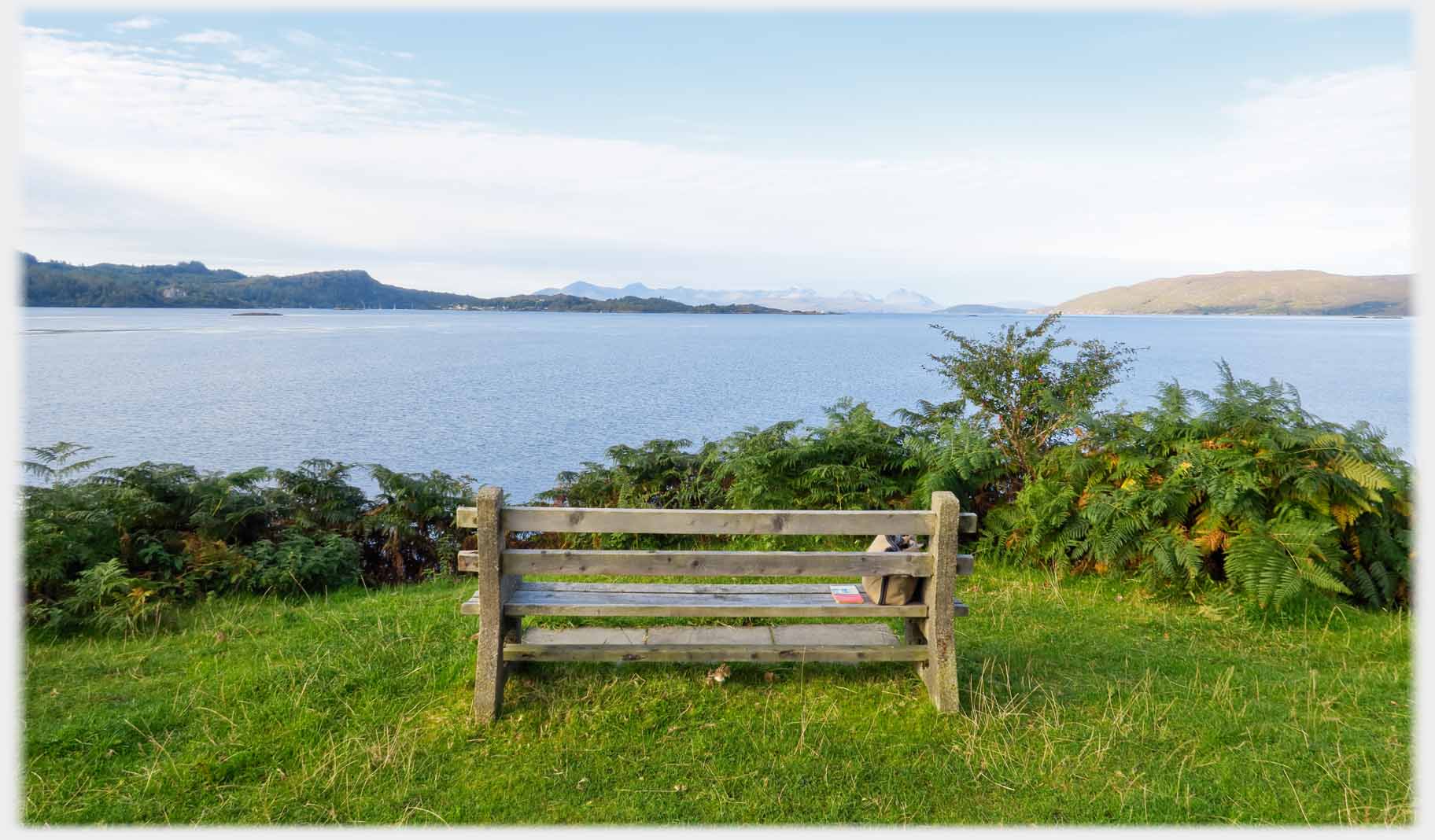 Seat looking  out to sea, Skye very small on horizon.