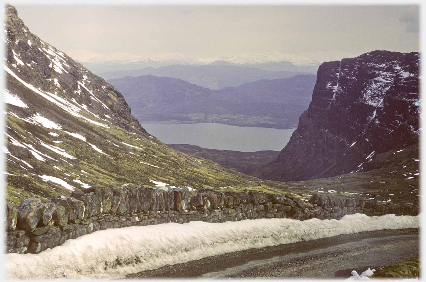 Looking down the pass to the sea, a little snow at roadside.