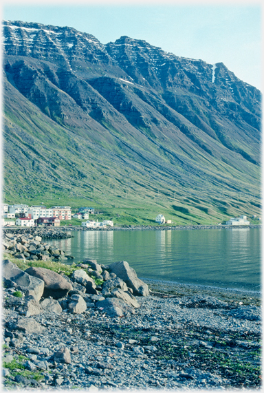 Houses under steep hillsides.