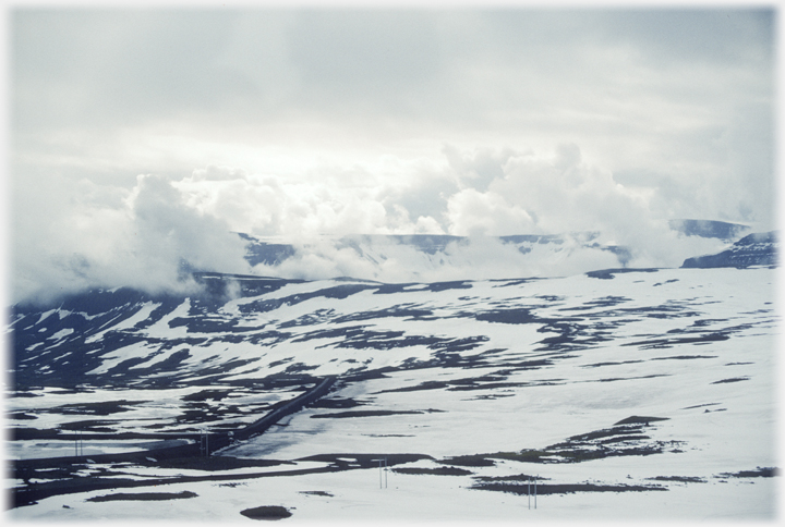 Clouds and snow on nearby pass.