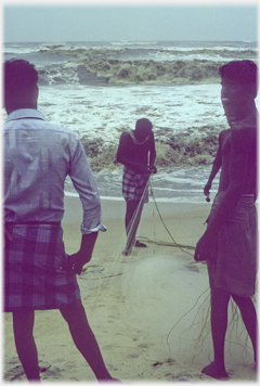 Three men silhouetted with their net.