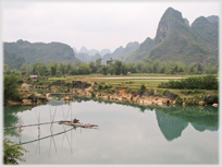 Pool with water pump and karsts in background.