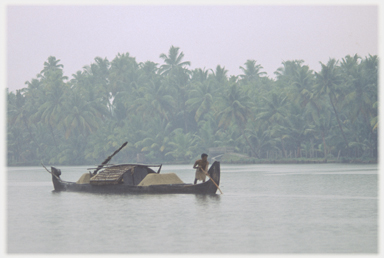 Man heaving on a punt pole.