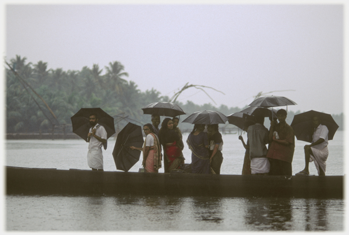 Line of passengers on punt ferry.