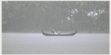 Two men bailing out a canoe.