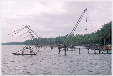 Two men working on nets.