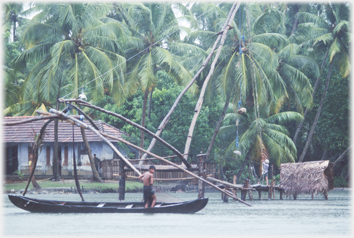 Canoe with man by a net.