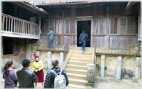 Mrs Chờ Vương showing visitors around the palace.