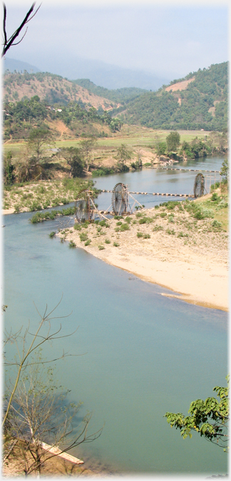 Vertical view looking up the valley with three large waterwheels and their barrages.