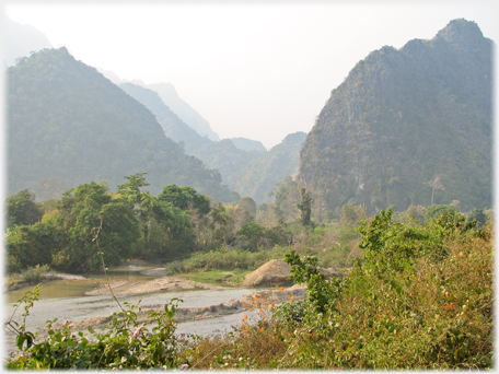 Foreground river with karsts beyond.