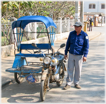 A motorbike with side by side seated sidecar.