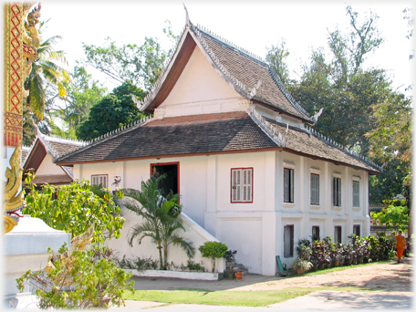 A white building with two layered roof.