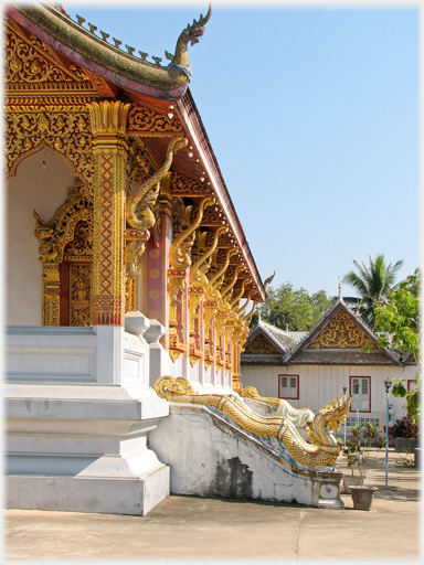 A view looking along the side of the building with its gilded roof supports.