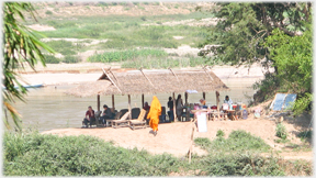 Monks (distantly) entering the riverside cafe.