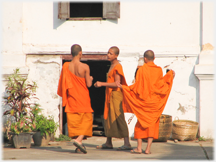 Three monks bodies curving.