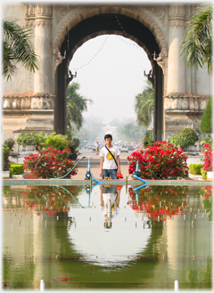Han framed and reflected in the Patuxai pond.