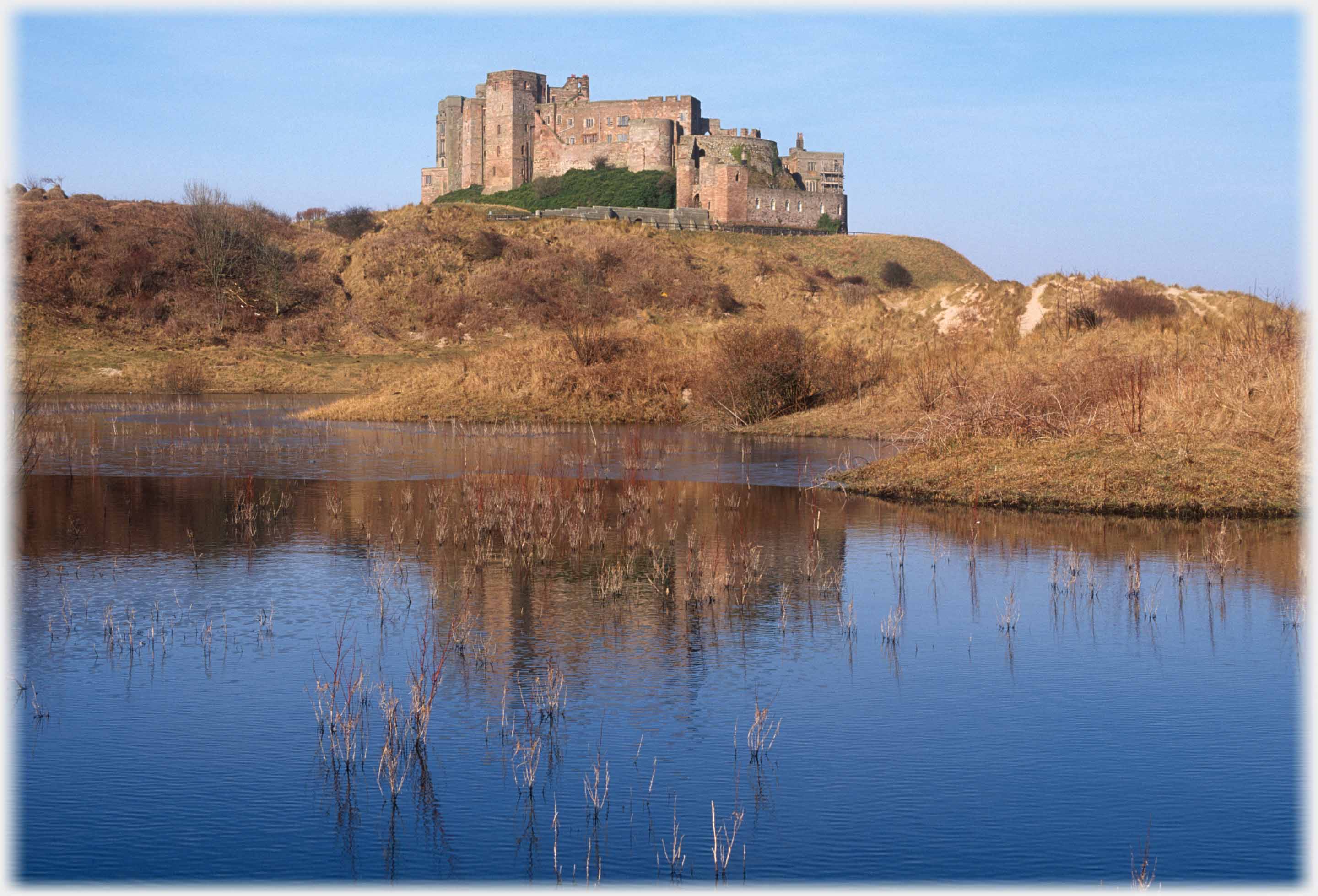 Castle on platform above small pool with ice visible.