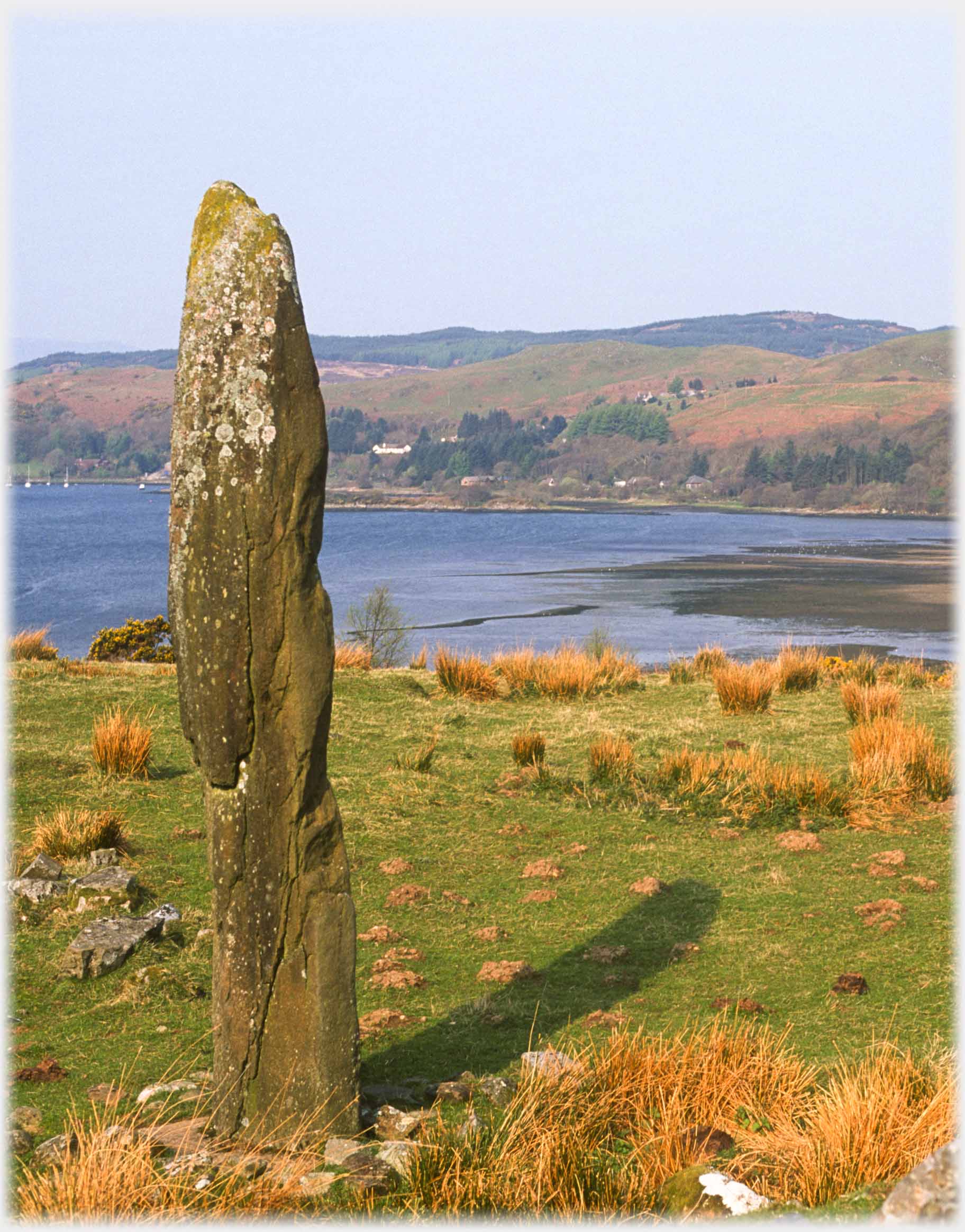 Monolith with  bay and hiills beyond.