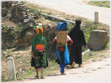 Man and two women walking.