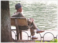 Man sitting by lake.