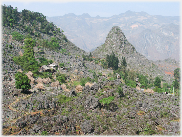 Village and haystacks by karst.