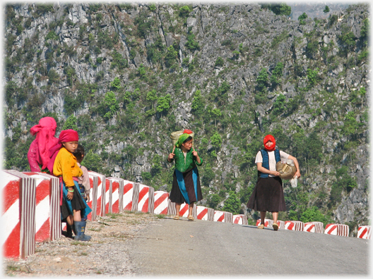 Women trudging up the road.