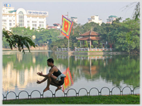 Man walking along railing, the Lake as background.